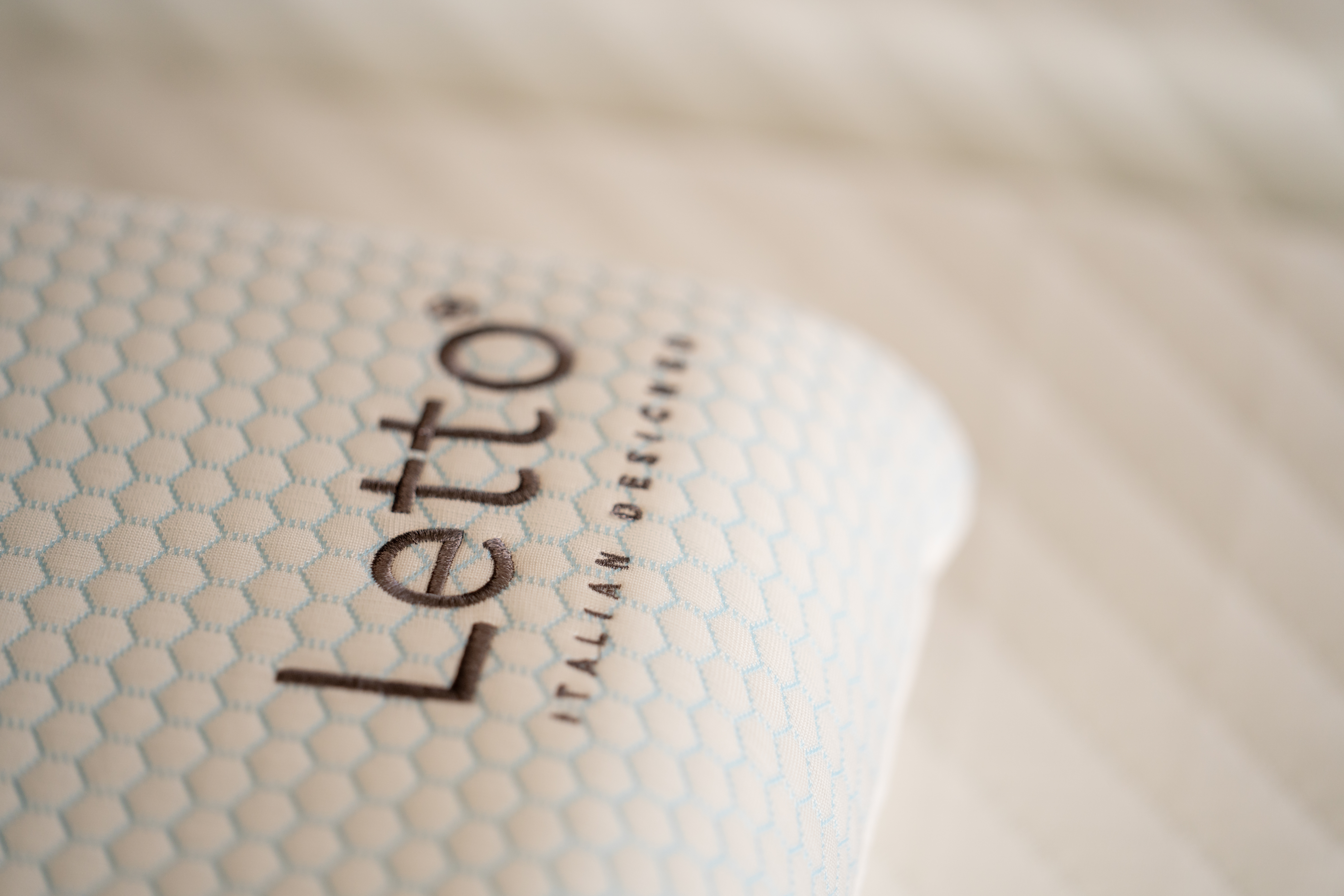 Close-up of a white Letto pillow showcasing its breathable, moisture-wicking textured fabric.